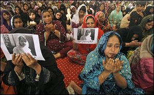 Supporters of Pakistani political party Muttahida Qaumi Movement, chant prayers in support of 14-year-old schoolgirl Malala Yousufzai, who was shot on Tuesday by the Taliban for speaking out in support of education for women.