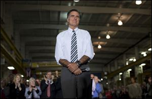 Republican presidential candidate, former Massachusetts Gov. Mitt Romney pauses during remarks at a town hall meeting at Ariel Corporation in Mt. Vernon, Ohio.
