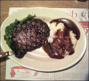Ribeye steak with mashed potatoes and gravy.