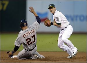 Jhonny Peralta slides after being forced out at second as Oakland Athletics shortstop Stephen Drew throws to first but too late for a double play on Andy Dirks on Tuesday in Oakland.