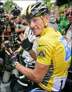 Lance Armstrong, of Austin, Texas, surrounded by press photographers, signaling seven,  for his seventh straight win in the Tour de France cycling race, prior to the start of the 21st and final stage of the race,  between Corbeil-Essonnes, south of Paris, and the French capital.
