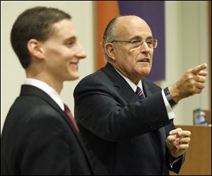 Former New York City Mayor Rudy Giuliani, right, speaks to Toledo-area supporters with Ohio State Treasurer Josh Mandel, left, during a roundtable discussion at  Health Care REIT.