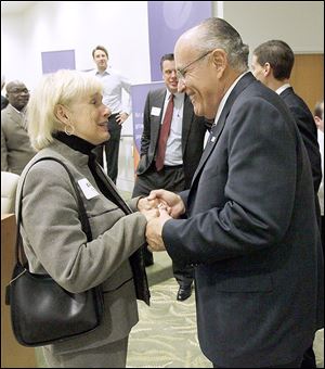 Former Toledo mayor Donna Owens, left, speaks with Former New York City Mayor Rudy Giuliani after a roundtable discussion Wednesday at  Health Care REIT.
