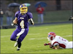 Elijah Bogosian eludes a player as he returns a kickoff earlier this month.