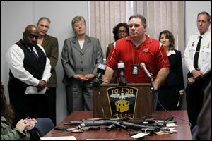 Detective Bill Noon, of the Toledo Police Department, discusses the arrest of 11 beehive gang members during a news conference Wednesday at the Safety Building in Toledo.