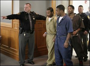 Keshawn Jennings, from left, Antwaine Jones, and James Moore, enter Lucas County Common Pleas Court, Thursday, October 11,  2012.  Each is charged with aggravated murder, murder, two counts each of attempt to commit aggravated murder, two counts of attempt to commit murder, four counts counts each of felonious assault, and improper discharge of a firearm into a habitation, in the murder of Keondra Hooks,1, and the shooting of her sister, Leondra Hooks, 2, at the Moody Manor apartment complex. 