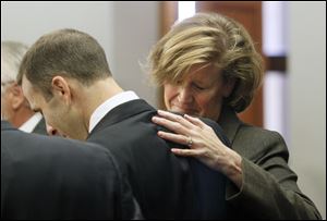 Tony Packo III and Cathleen Dooley freact after being not guilty in Lucas County Common Pleas Court, Thursday.