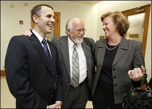 Tony Packo III, left, attorney Rick Kerger, and Cathleen Dooley celebrate after Packo III and Dooley were found not guilt in Lucas County Common Pleas Court on Thursday. They were charged with theft from the Tony Packo's restaurant company. 