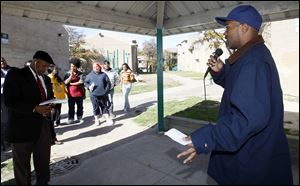 Resident Simmie Lassiter speaks as residents of Greenbelt Place apartments hold a rally at the complex.