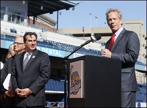 Randy Oostra President and CEO at ProMedica Health System, at podium, along with  the ECHL, and the Toledo Walleye, announce plans to hold a Winterfest and outdoor hockey game at Fifth Third Field.  Walleye president and general manager Joe Napoli looks on, left.