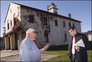 Block watch captain Sy Kreais speaks with Toledo City Council president Joe McNamara, who held a press conference outside Toledo Fire Station 3 in Toledo, Ohio to claim the station, built in 1927, can be saved. The city has already announced that, after a fault was found in the floor, the station would be replaced.