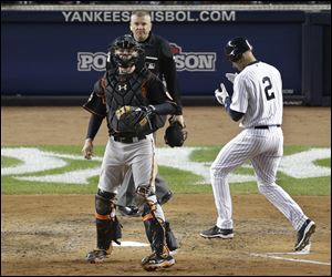New York Yankees' Derek Jeter scores on an RBI double by Ichiro Suziki during the sixth inning today at Yankee Stadium in New York.