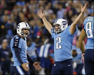 Tennessee Titans kicker Rob Bironas (2) reacts with holder Brett Kern after kicking the game-winning field goal against the Pittsburgh Steelers on Thursday night in Nashville.