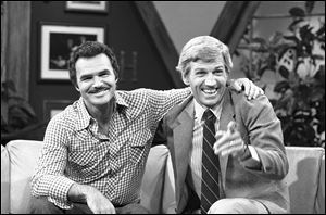 Actor and talk show host Gary Collins, right, reacts to a joke told on the set of Hour Magazine in Los Angeles during a break in taping  Wednesday, July 30, 1981 with guest Burt Reynolds. 