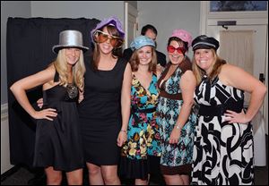 Wedding guests are ready for a trip into a photo booth sponsored by Exceptional Receptions in Binghamton, New York. Couples are starting to include photo booths as an activity for the guests during wedding receptions. Wedding planners say the activities make the evening more fun.