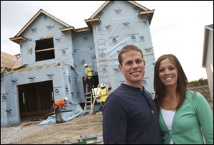 Mike and Ann Jeweson, both in the twenties, are taking advantage of low interest rates to make the four-bedroom home under construction behind them their first home.