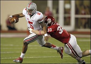 Ohio State quarterback Braxton Miller is taken down for a loss by Indiana defensive end Zack Shaw during the first half Saturday in Bloomington, Ind.