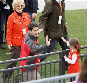 Republican vice-presidential candidate, U.S. Rep. Paul Ryan, gets a high-five from Ava Santa Maria, 4, of Twinsburg, Ohio, inside Doyt Perry Stadium at  Bowling Green State University, prior to the start of Bowling Green-Miami University football game, Saturday, October 13, 2012.  BGSU president Mary Ellen Mazey looks on.  