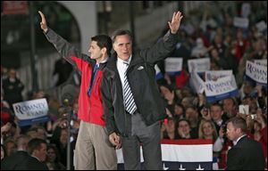 Republican Presidential candidate Mitt Romney and Republican Vice Presidential candidate Paul Ryan wave goodbye Friday after a victory rally held in the town square in Lancaster.