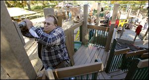 Volunteer Kevin Smith helps build Imagination Kingdom. The work will be done, and the park opened, on Sunday.