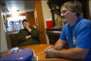Former Manufacturing Company employees Ron Nixon, left, and Jamie Haas sit around the Haas family's kitchen table and talk about the state of the nation. Nixon, who says he is a registered Republican, feels the party has passed him by.