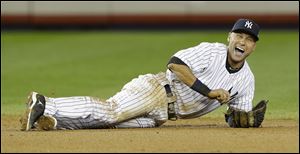 New York Yankees shortstop Derek Jeter reacts after breaking his ankle in the 12th inning.