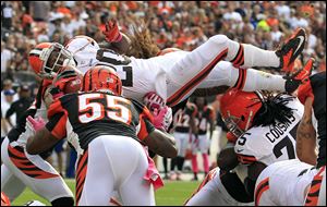 Cleveland Browns running back Montario Hardesty (20) leaps for a 1-yard touchdown against the Cincinnati Bengals in the fourth quarter of an NFL football game Sunday.