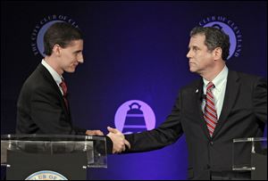 U.S. Sen. Sherrod Brown (D., Ohio), right, shakes hands with Republican challenger, Ohio state treasurer Josh Mandel, after their debate at the City Club in Cleveland.