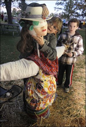 Cygnet, Ohio residents Bella Byram, 8, and Bryan Byram, 11, build a scarecrow.