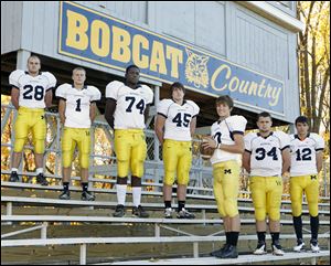 Whiteford High School football players Brian Tabbert (28), Colin Lake (1), Chris Sims (74), Troy Diller (45), Gabe LaRoy (10),  Tyler Lee (34), and Zach Perry (12).