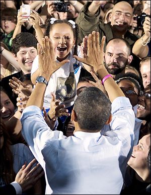 President Obama greets a girl in the audience at  Ohio University. The visit marked Mr. Obama's first campaign stop in southeast Ohio.