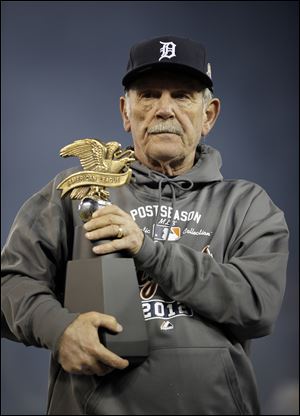 Tigers manager Jim Leyland holds the William Harridge Trophy after his team won the American League championship series.