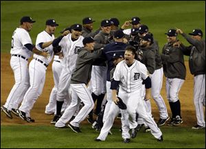 Tigers pitcher Phil Coke and teammates celebrate after winning Game 4 in Detroit.