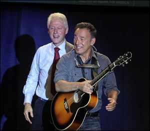 Former president Bill Clinton, left,  introduces Bruce Springsteen at a Democratic rally at Tri-C Western Campus in Parma on Thursday.
