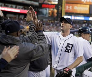 Detroit Tigers' Max Scherzer is congratulated by teammates after being taken out of the game in the sixth inning.