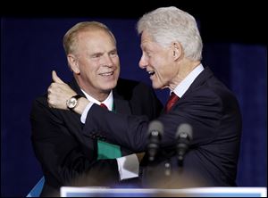 Former President Bill Clinton gives a thumbs up after being introduced by former Ohio Gov. Ted Strickland.