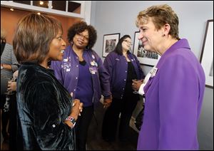 Actress Alfre Woodard, left, speaks with SEIU President Mary Kay Henry, right, prior to a womenÕs roundtable at Petit Fours Bakery in Toledo.