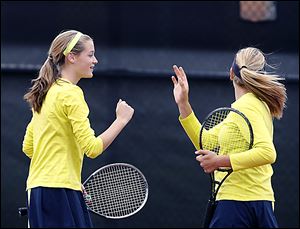 Notre Dame Academy sophmore Teagan McNamara, left, celebrates a point as doubles partner Alicia Nahhas watches the shot land just out of bounds.