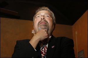 Maumee mayor Tim Wagener watches early voting results during an election night poll watching party in 2011.