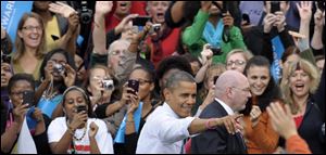 President Barack Obama responds to the crowd Friday during a campaign event at George Mason University in Fairfax, Va.