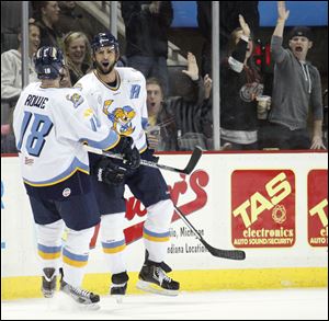 Walleye players Randy Rowe, 18, and Wes O'Neill, 5, celebrate O'Neill's goal against the Cincinnati Cyclones during the second period Friday at the Huntington Center.