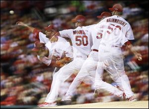 Cardinals starting pitcher Adam Wainwright pitches in a multiple-exposure sequence in fifth inning Thursday during Game 4 of the National League Championship Series between the St. Louis Cardinals and the San Francisco Giants.
