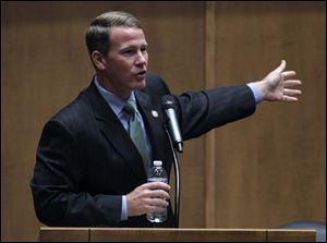 Ohio Secretary of State Jon Husted gives the keynote address during a public symposium Friday at the University of Toledo Law School.