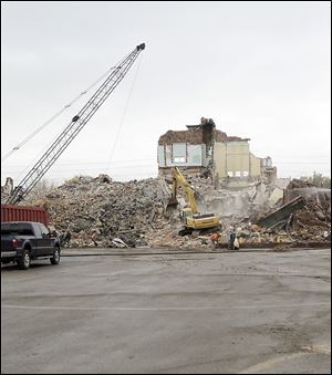 A wrecking crew reduces the former Longfellow Elementary School on Jackman Road to rubble. A new Longfellow opened this year on Laskey Road west of Jackman. The fireplace in the old building was preserved. It was incorporated into the new building's library.
