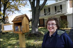 Marilyn Machosky, and her husband Stan, have officially opened their neighborhood library in the front yard of their home in Sylvania. Any passerby may take a book and though patrons are encouraged to return them, it is not necessary to bring the same book back.  