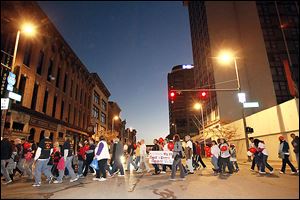 The survivors parade makes its way across North Summit Street near SeaGate Centre on Sunday during the Leukemia & Lymphoma Society's annual Light The Night Walk. The Light the Night Walk is a national fund-raiser that commemorates and celebrates lives touched by blood cancers. The event also featured musical entertainment and children’s activities.
