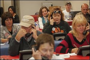 Amanda Metcalf of Maumee center top, joins 35 other volunteers at the Republican Victory Center in Maumee on Saturday to call prospective voters.