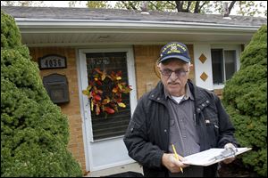 Republican volunteer Bob Henold of Toledo canvasses homes on Heatherdowns Boulevard, encouraging voters to cast ballots early.