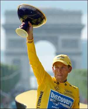 Lance Armstrong holds the winner's trophy after claiming his seventh straight Tour de France cycling race during ceremonies on the Champs-Elysees avenue in Paris July, 2005.