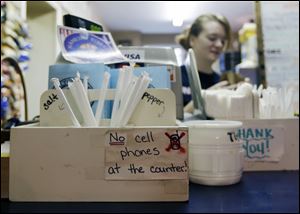 A sign at the Hamilton Street Cafe advises customers about their cell phone policy at the restaurant in Albany, N.Y.